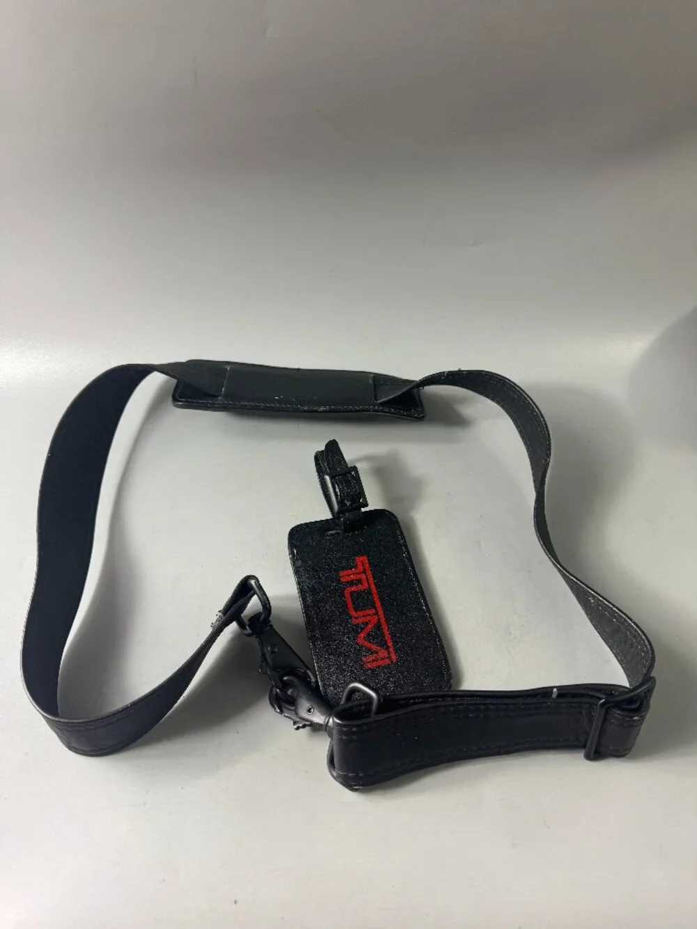 A Bundle of Two (2) Vintage Tumi Black Leather Strap and Travel Tag